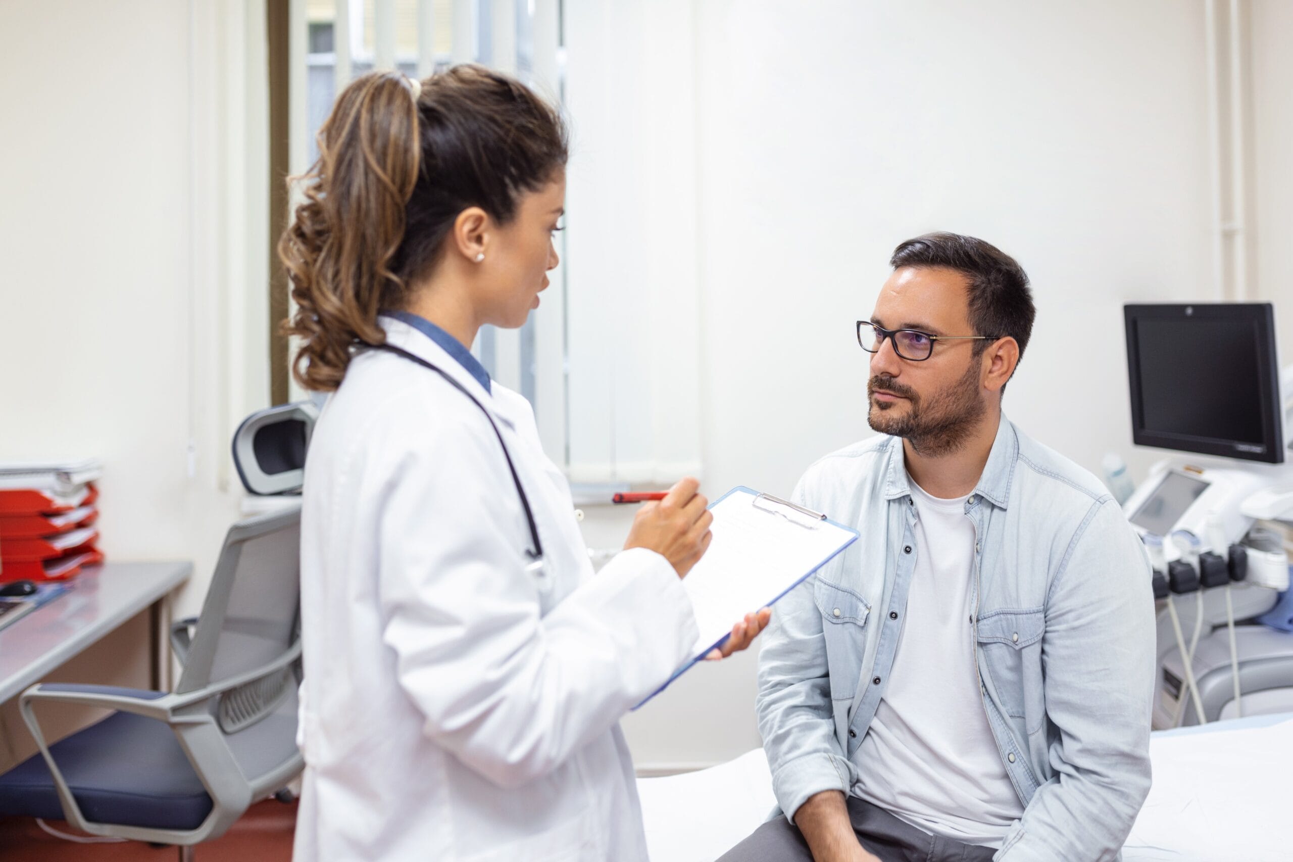 Doctor consulting with a patient, discussing treatment options in a clinical setting.