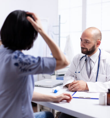 Doctor consulting a patient with migraines during a medical appointment, discussing medication options.