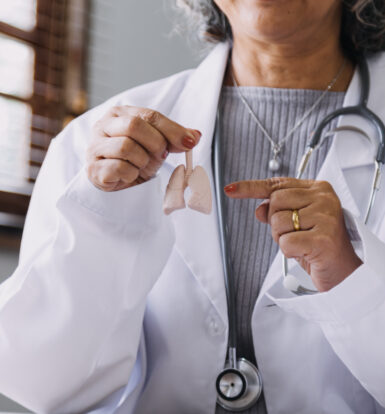 Doctor holding a lung model, explaining COPD medication and treatment options