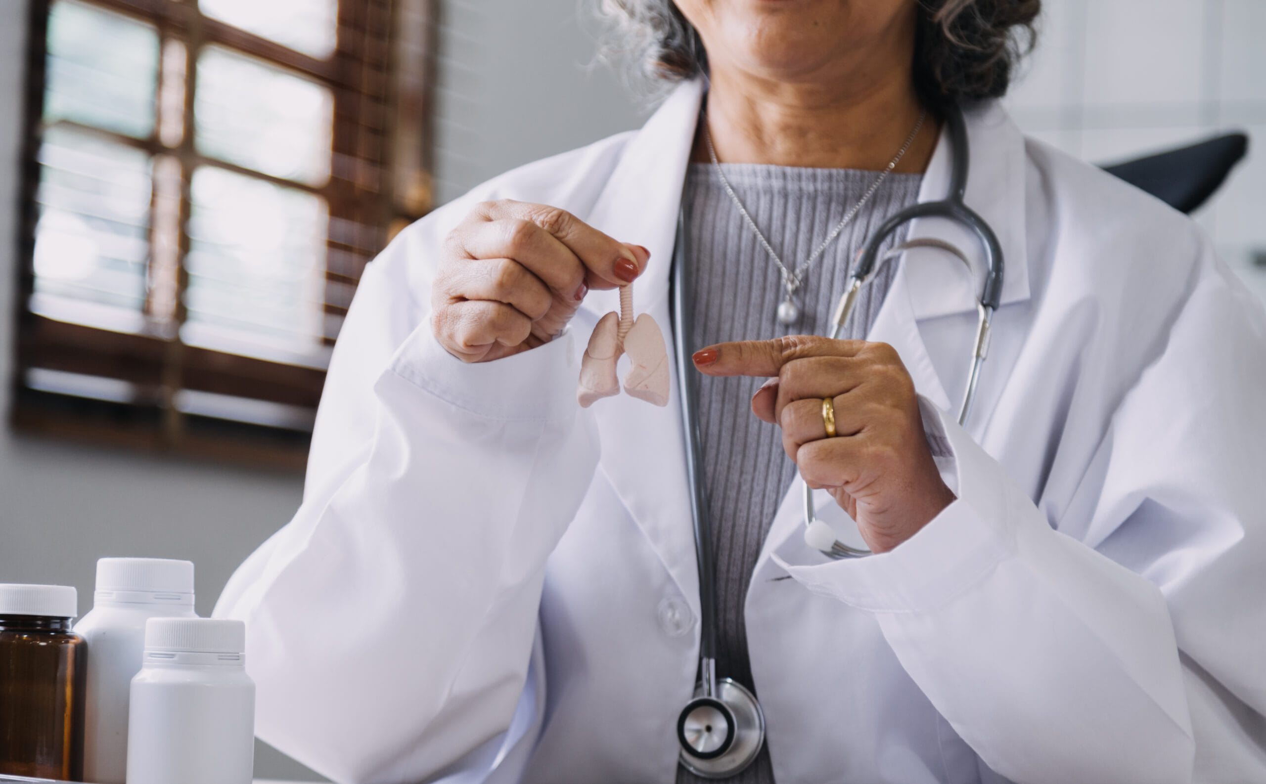 Doctor holding a lung model, explaining COPD medication and treatment options