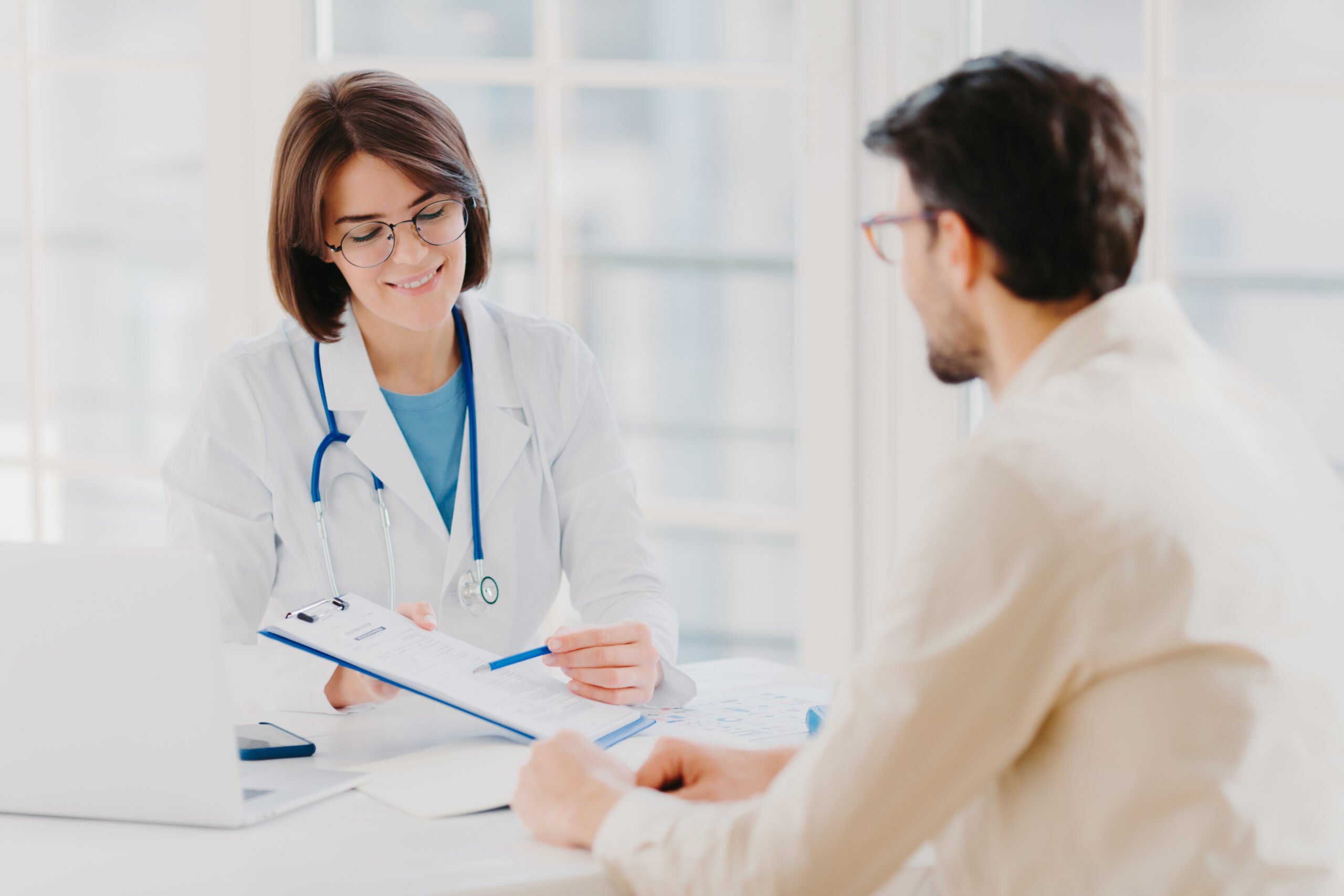 Doctor consulting with a patient about the prior authorization process for Oxycodone to manage chronic pain.