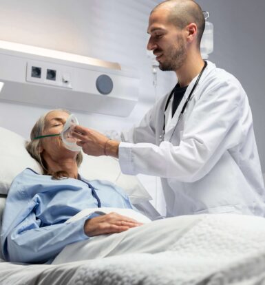 Healthcare provider assisting a patient with oxygen support in a clinical setting.