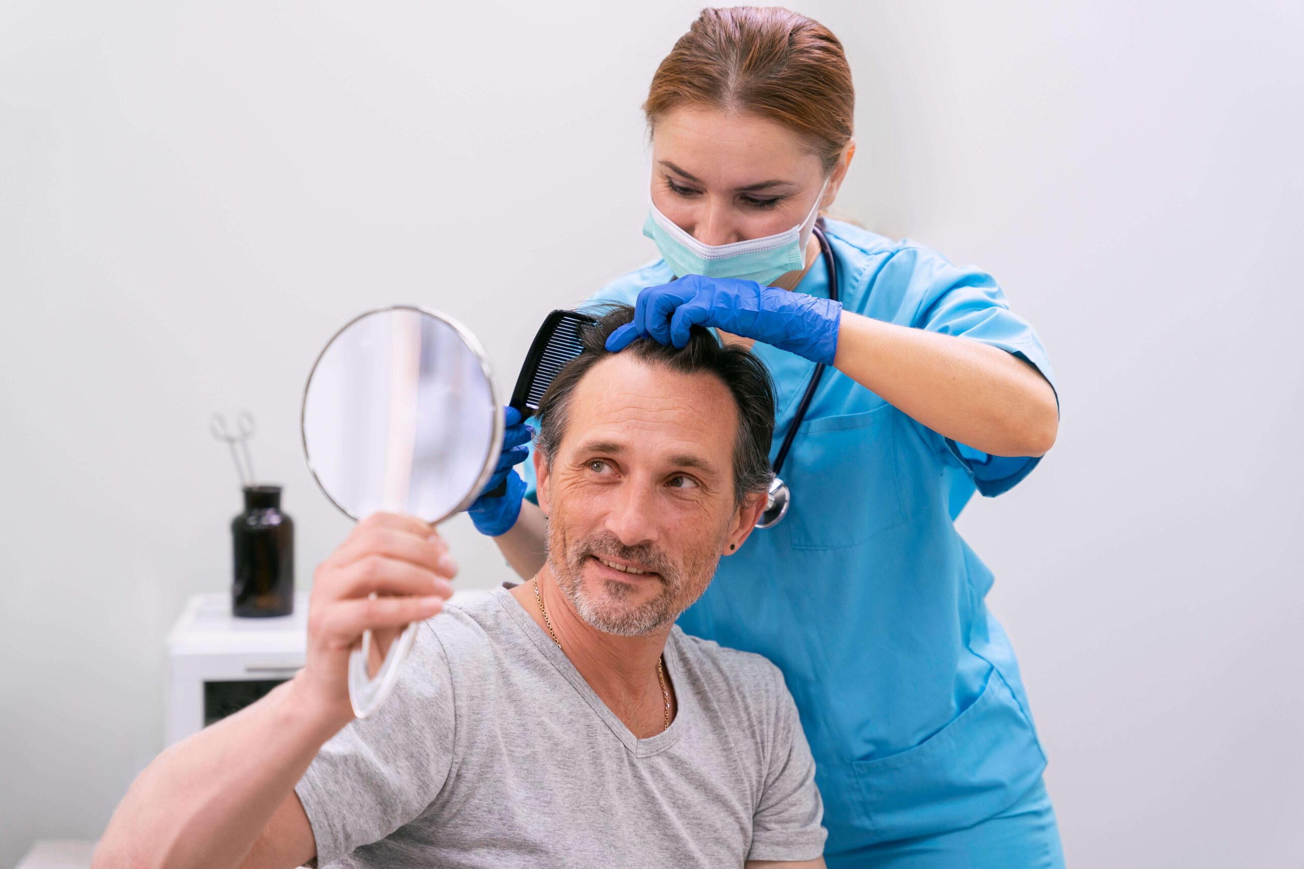 Doctor checking patient's scalp during a consultation, showing concern for hair health and well-being.