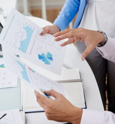 Healthcare professionals reviewing revenue cycle management reports and charts to improve medical coding accuracy and efficiency.