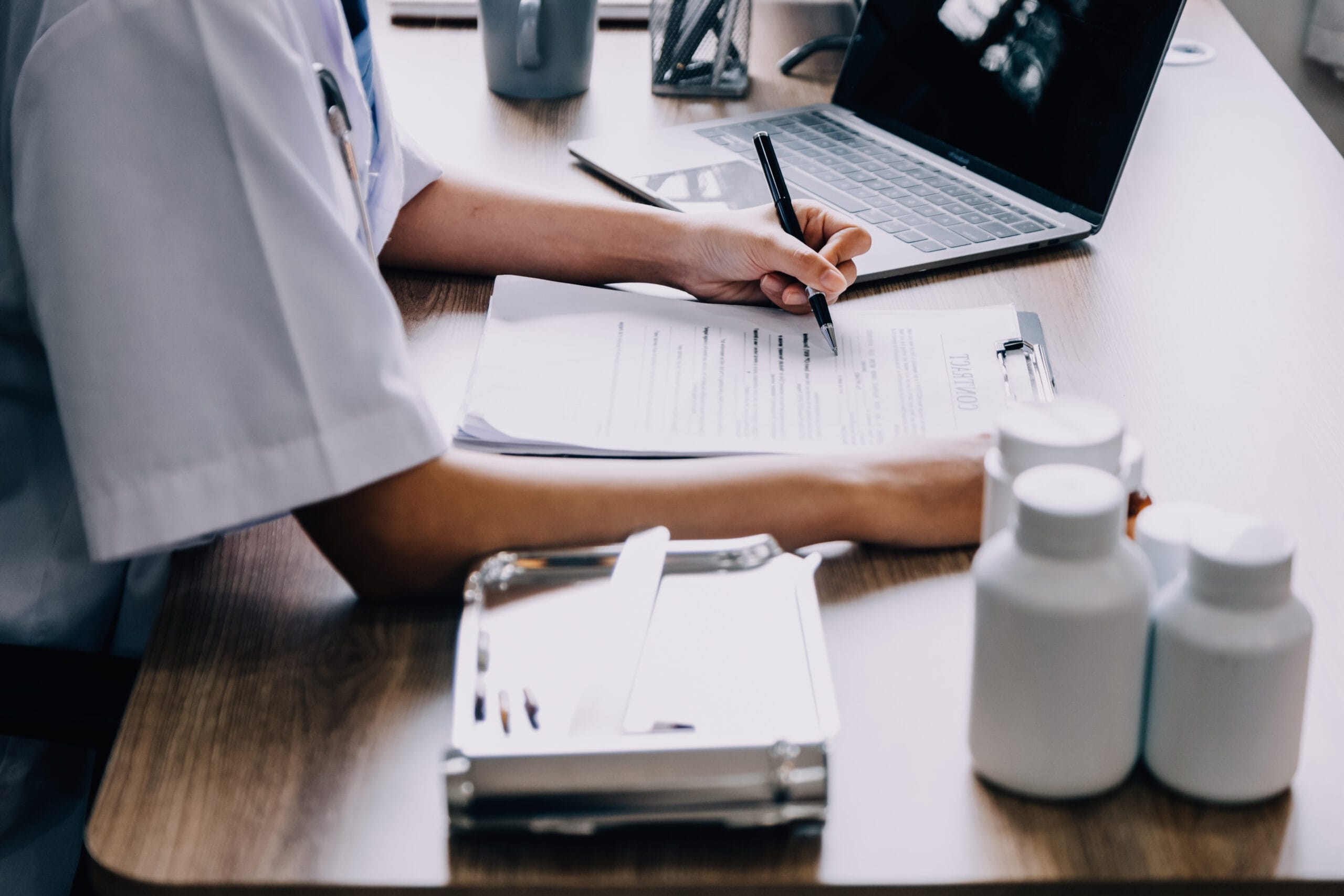 A healthcare provider consulting with a patient while using outsourced medical scribing and coding services.