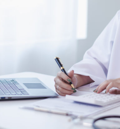 A medical scribe and coder working together in a healthcare setting.