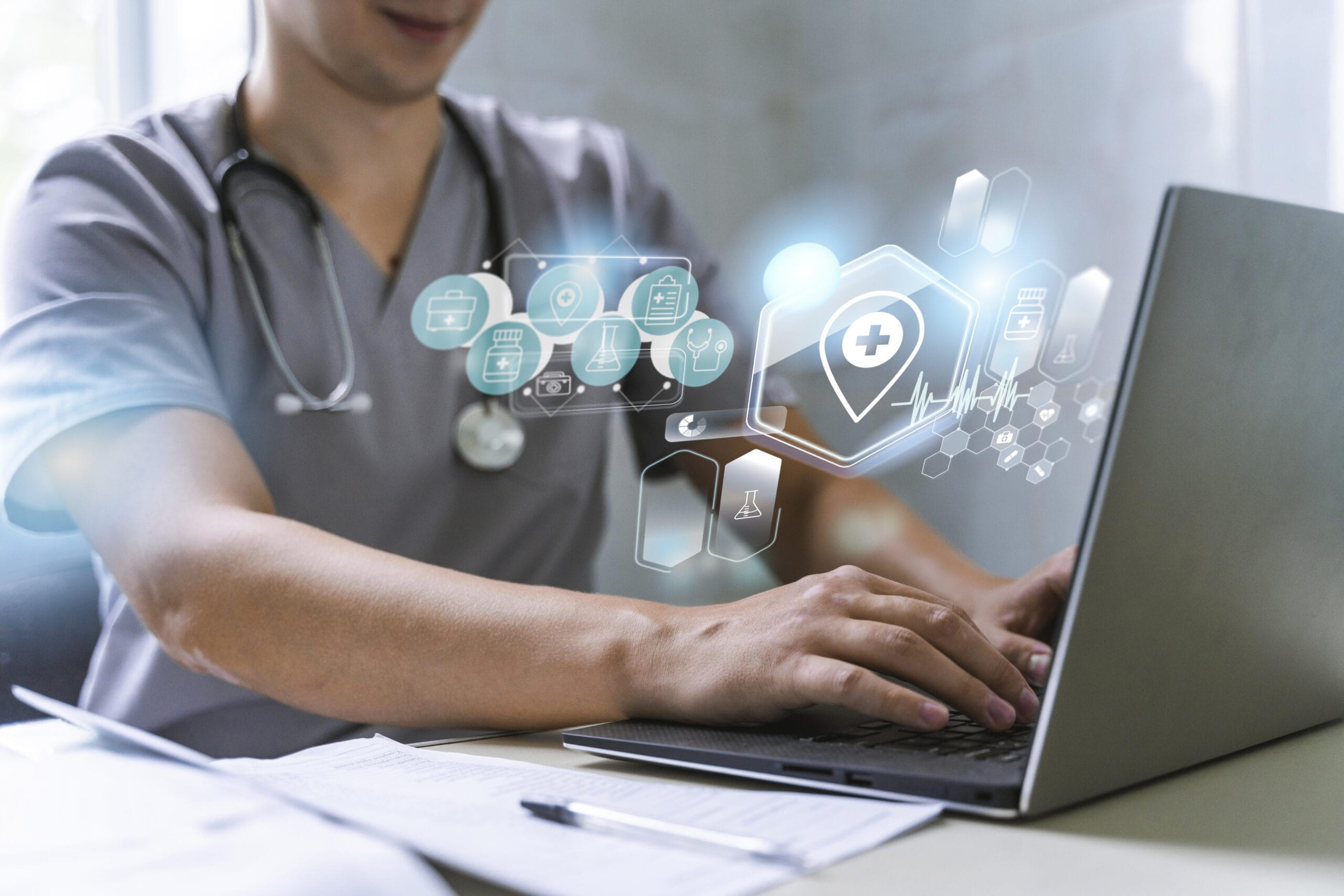 A healthcare provider typing on a laptop with holographic medical icons representing technology in medical scribing and coding.