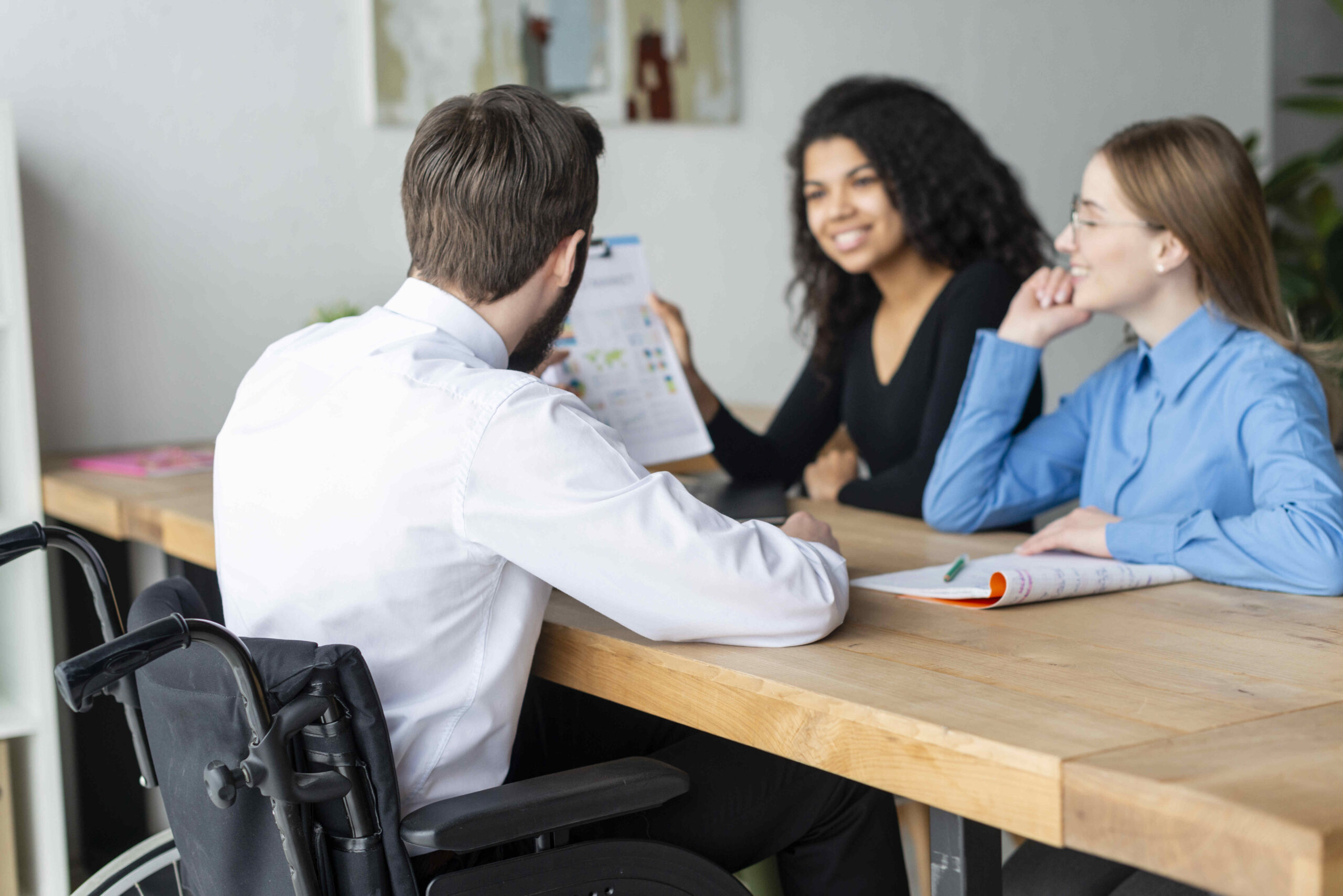 A team meeting discussing health insurance verification strategies, with a focus on accessibility and inclusivity