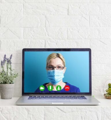 Virtual medical assistant conducting an online consultation displayed on a laptop screen, enhancing healthcare efficiency remotely.