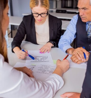 ealthcare administrators reviewing insurance verification documents to ensure accurate eligibility checks and prevent claim denials.