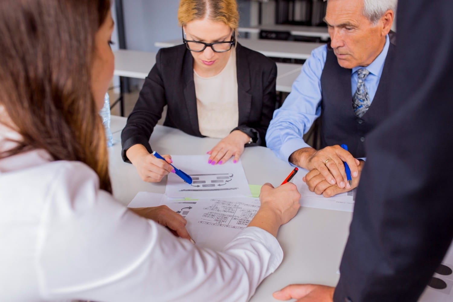 ealthcare administrators reviewing insurance verification documents to ensure accurate eligibility checks and prevent claim denials.