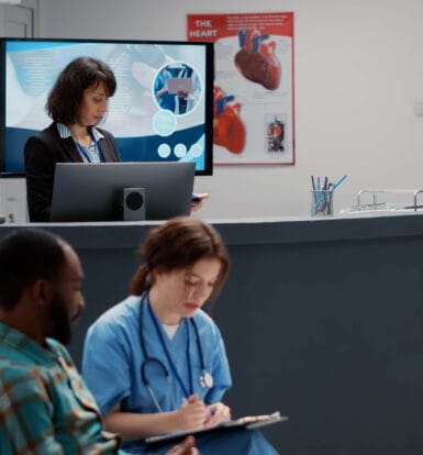 A hospital reception area with a receptionist working on a computer, a nurse reviewing patient files, and a patient waiting. The scene highlights administrative efficiency in healthcare settings.