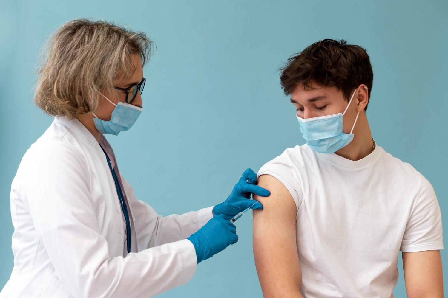 Healthcare provider administering an injection to a patient during growth hormone therapy, highlighting prior authorization processes.