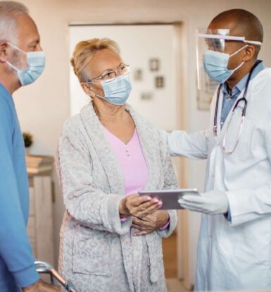 A doctor discussing a prior authorization process with elderly patients, focusing on medication approval and healthcare planning.