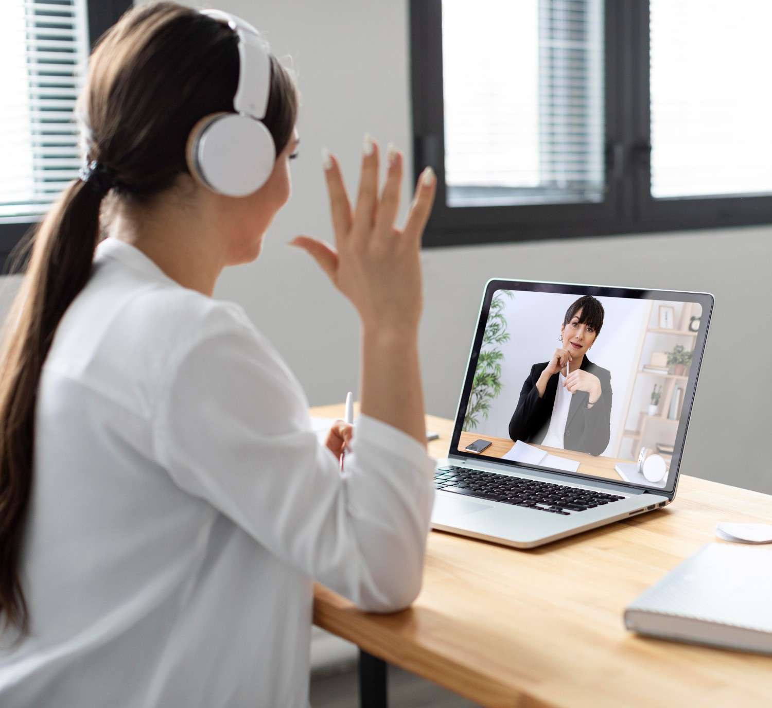 A healthcare professional engaging in a video consultation with a virtual medical assistant, showcasing remote administrative support in healthcare.