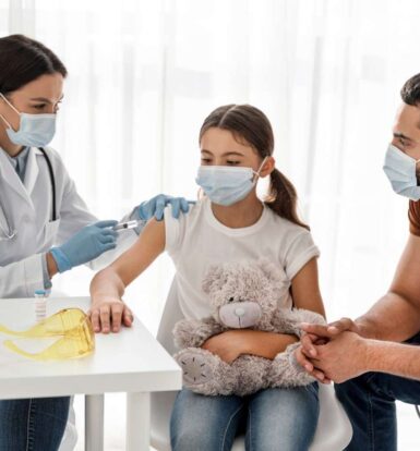 Doctor administering a vaccine to a young girl while her father watches, symbolizing care and precision in healthcare services.