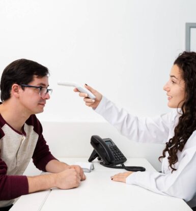 A healthcare provider using a medical device to assess a patient’s health during a consultation for Omnitrope prior authorization.