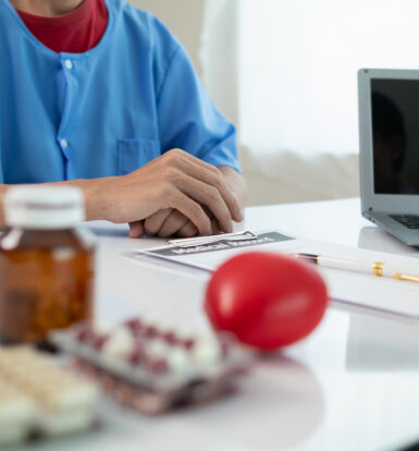 A stressed healthcare worker handling prior authorization paperwork.