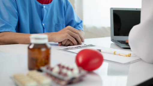 A stressed healthcare worker handling prior authorization paperwork.