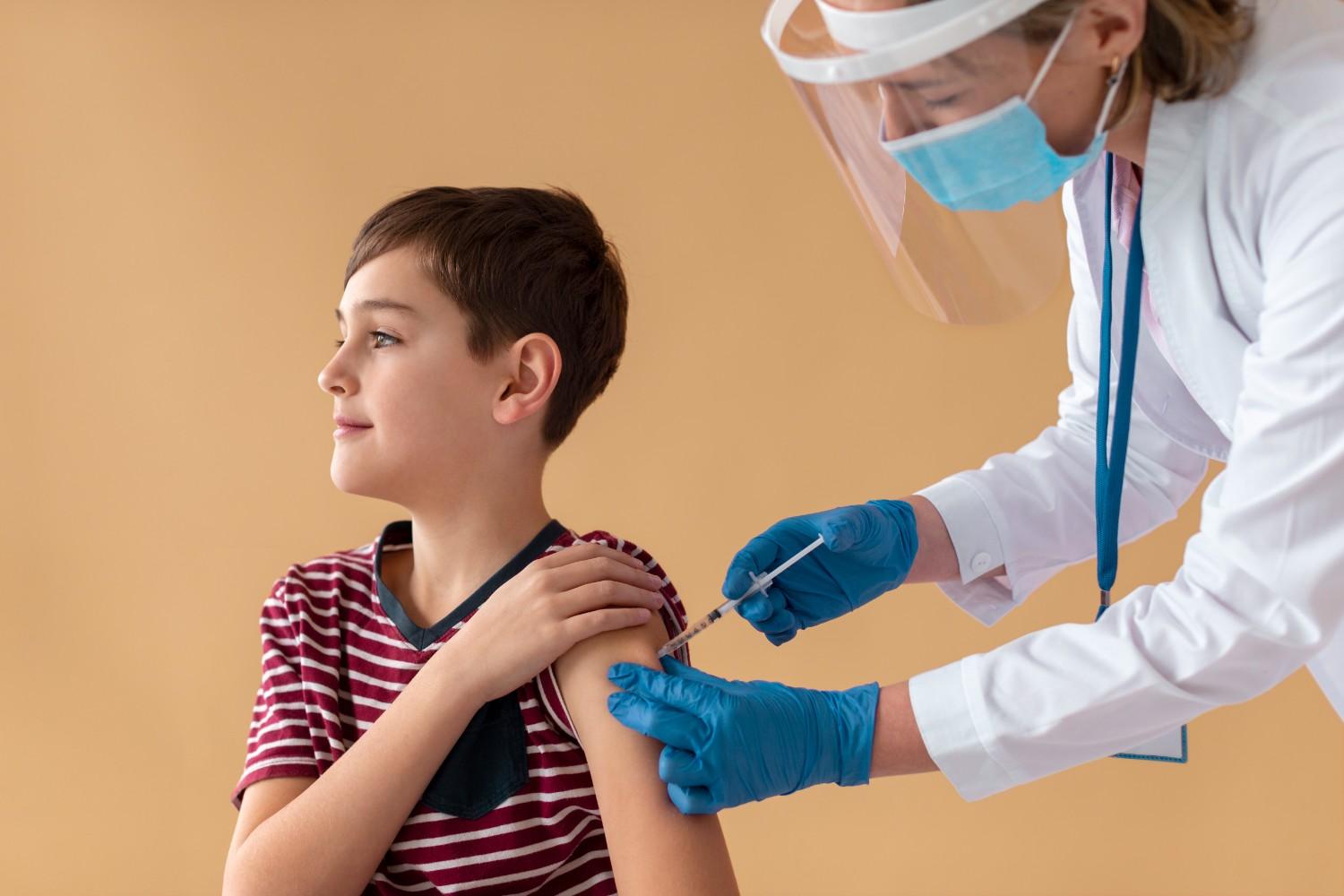 Healthcare provider administering an injection to a young patient as part of growth hormone therapy.