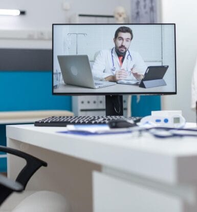 A doctor conducting a telemedicine consultation on a computer screen, highlighting virtual medical assistance in remote healthcare.