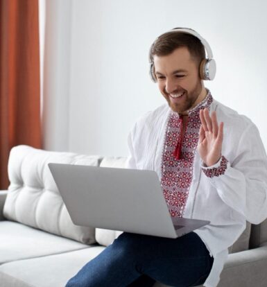 A smiling virtual assistant in headphones engaging in an online meeting, showcasing modern remote healthcare support.