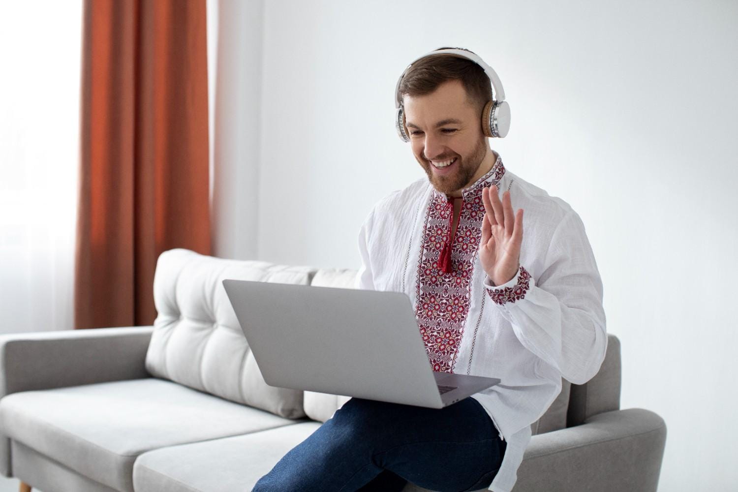 A smiling virtual assistant in headphones engaging in an online meeting, showcasing modern remote healthcare support.