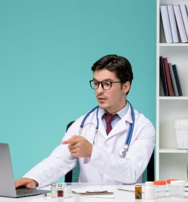 Doctor using a laptop for virtual medical assistant services in a healthcare setting.