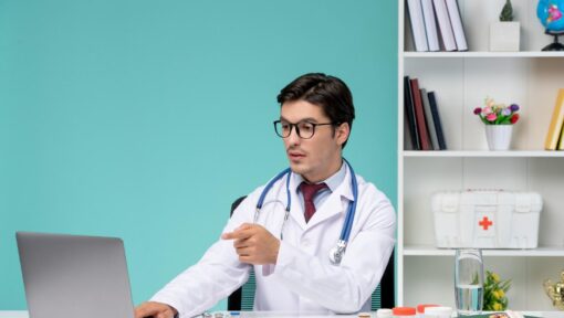 Doctor using a laptop for virtual medical assistant services in a healthcare setting.