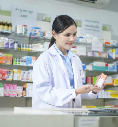 Pharmacy technician using an automated billing system.