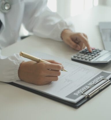 A medical coder analyzing data on a computer to ensure billing accuracy.