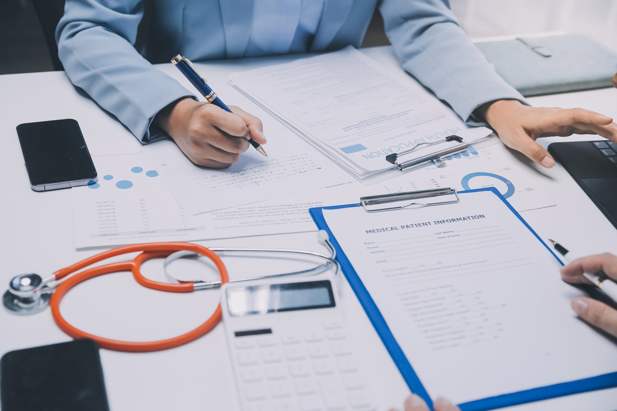 A medical coder working on patient documentation and codes in a healthcare setting.