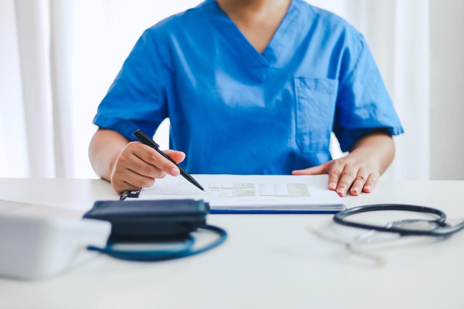 A healthcare provider working with a virtual scribe in real-time