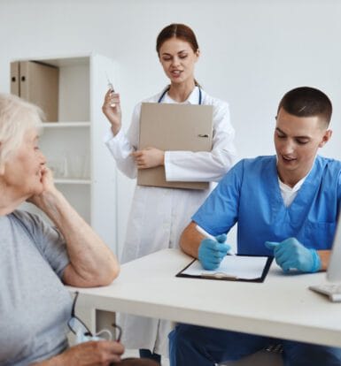 A medical coding professional reviewing patient records and codes.