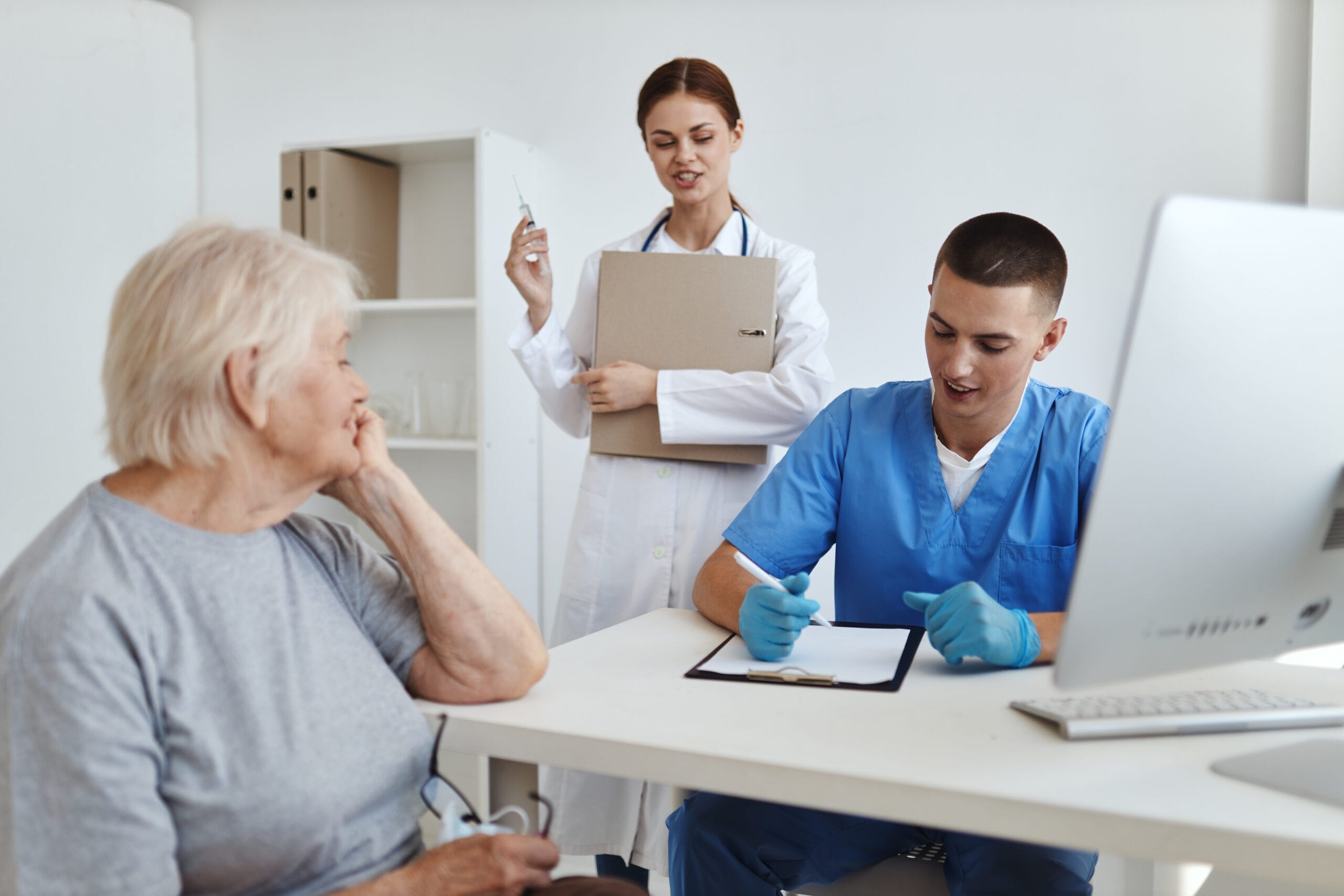 A medical coding professional reviewing patient records and codes.