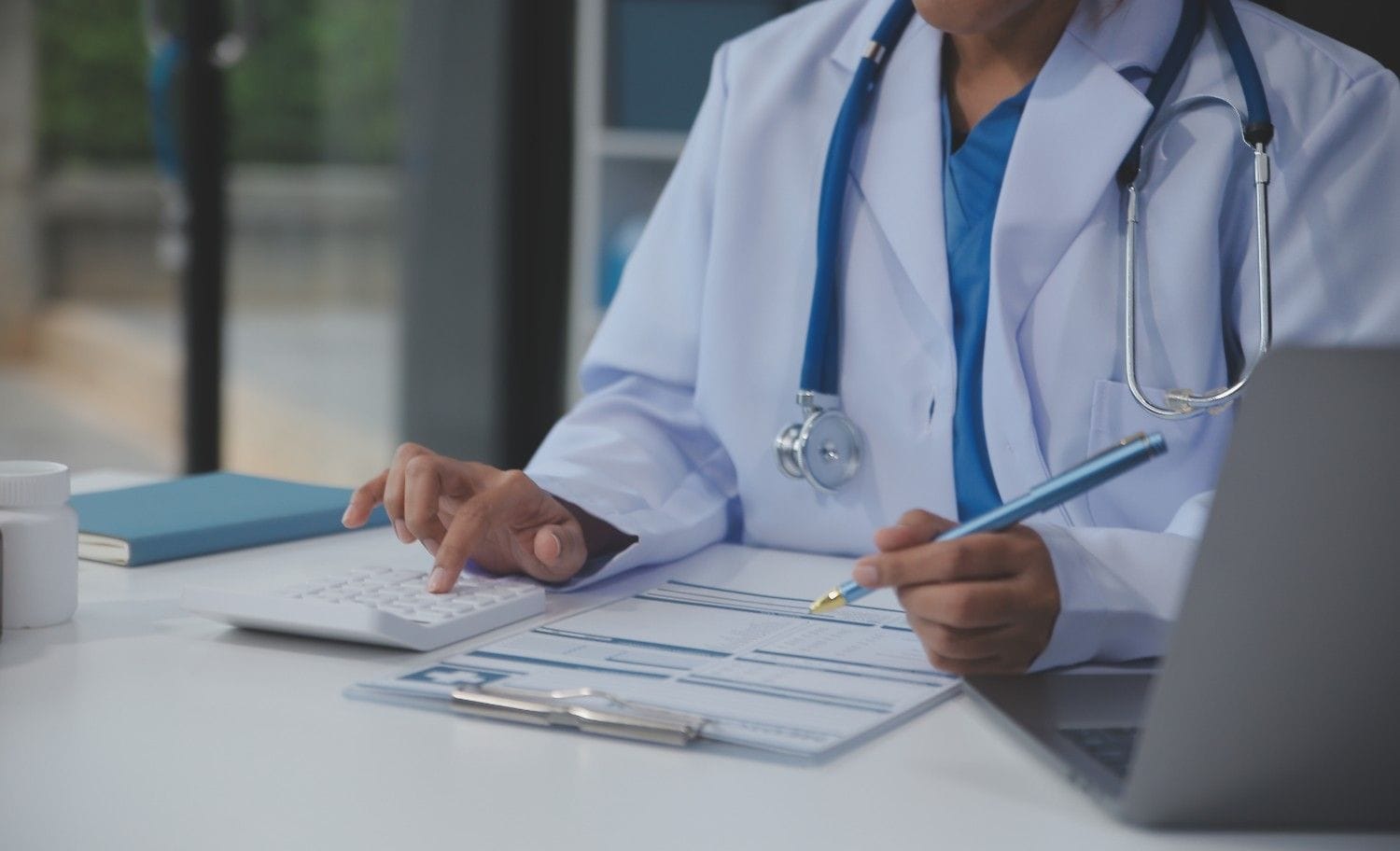 A medical scribe documenting a provider-patient interaction in a specialty clinic.