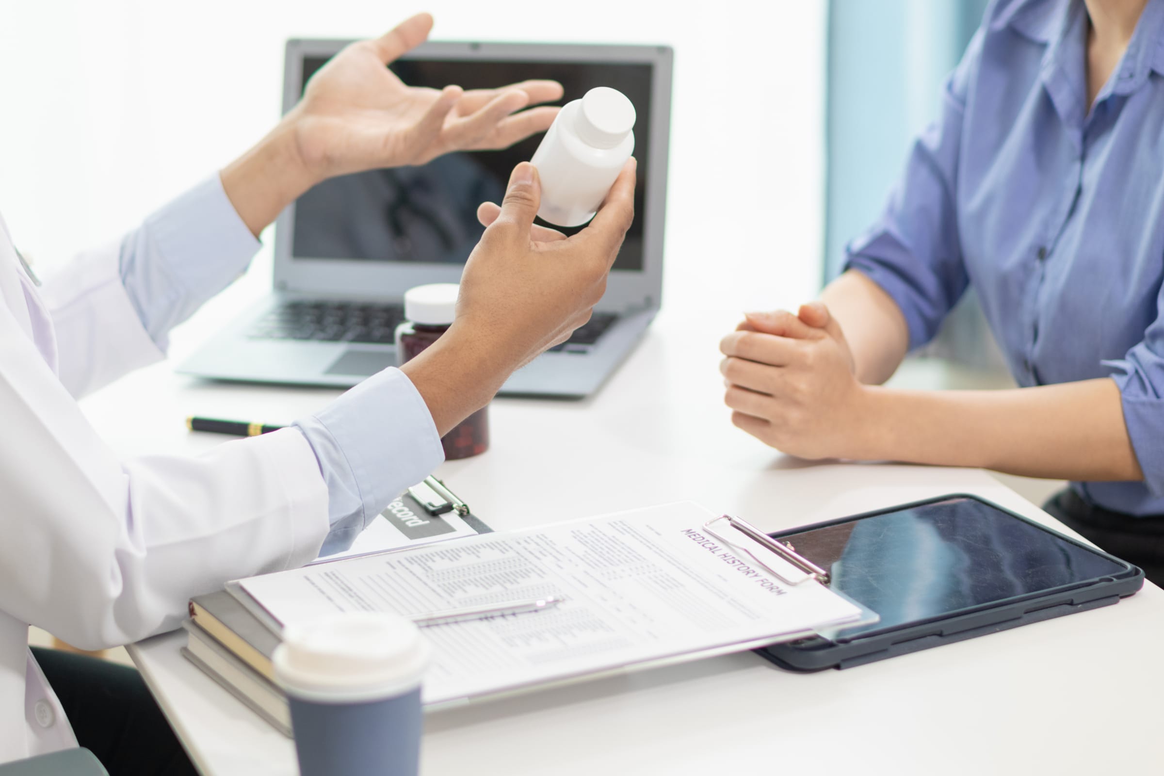 A healthcare administrator reviewing prior authorization requirements on a computer.