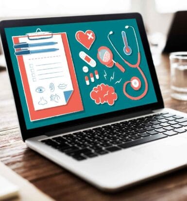 Medical tools and a clipboard illustration on a laptop screen for healthcare SEO.