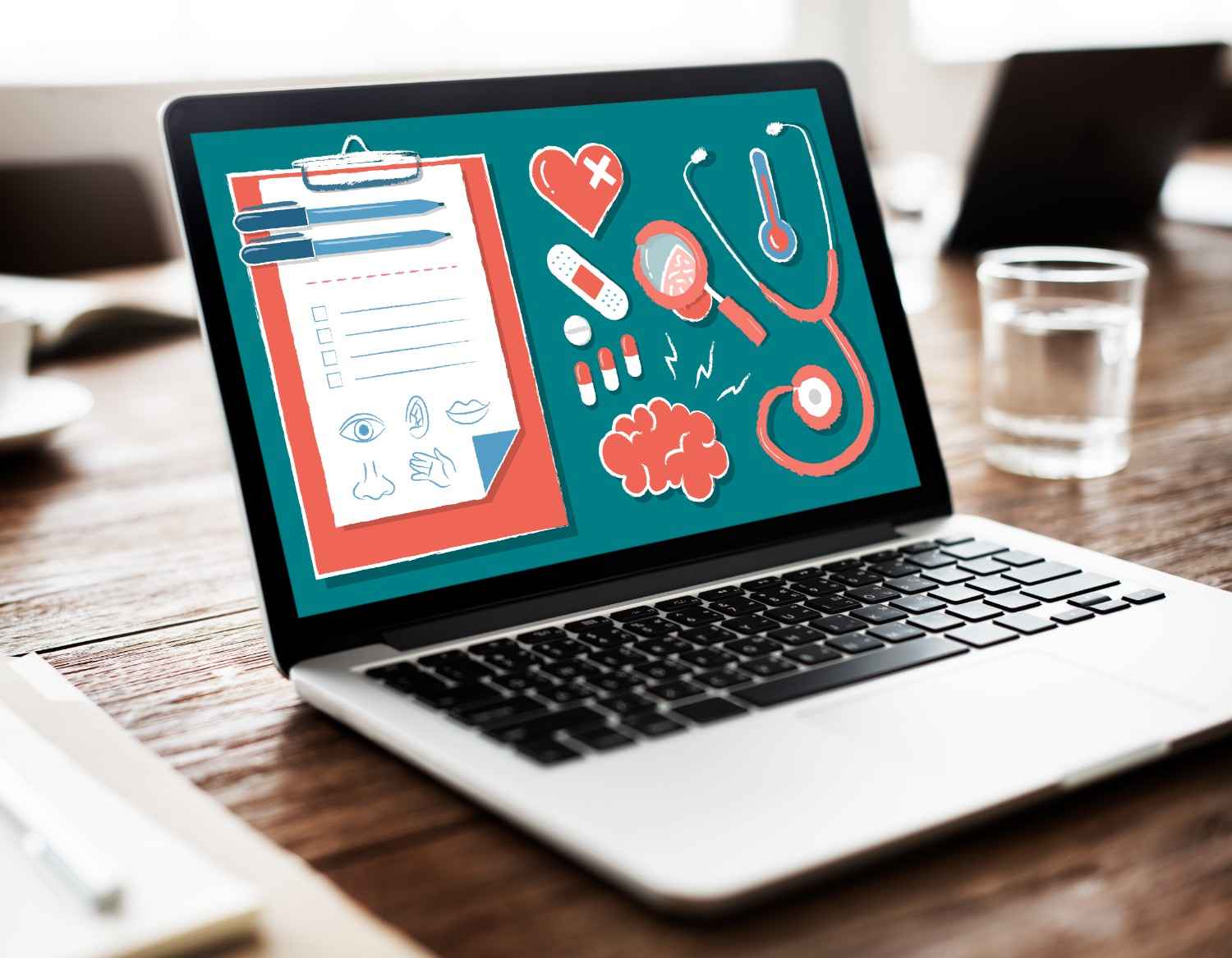 Medical tools and a clipboard illustration on a laptop screen for healthcare SEO.