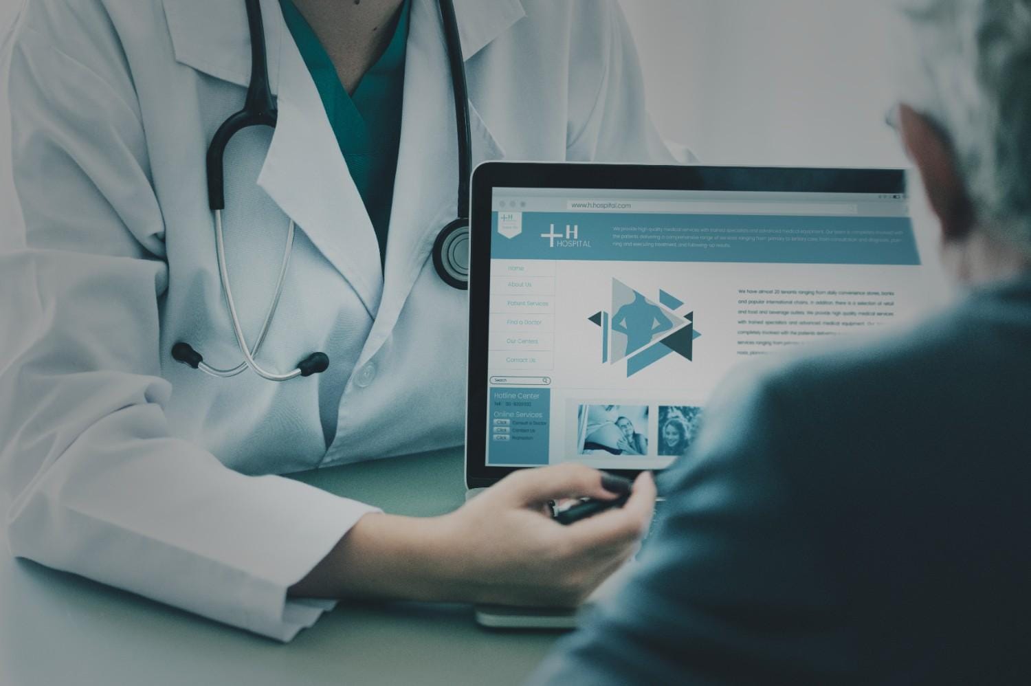 Doctor explaining healthcare services on a laptop to a patient.