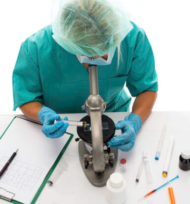 A healthcare provider consulting with a patient using telemedicine while a medical scribe documents notes.