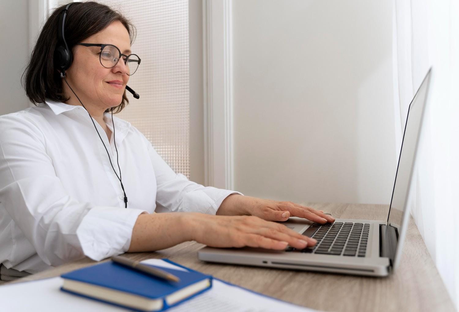 Virtual medical assistant working remotely on a laptop while assisting a healthcare practice with administrative tasks.