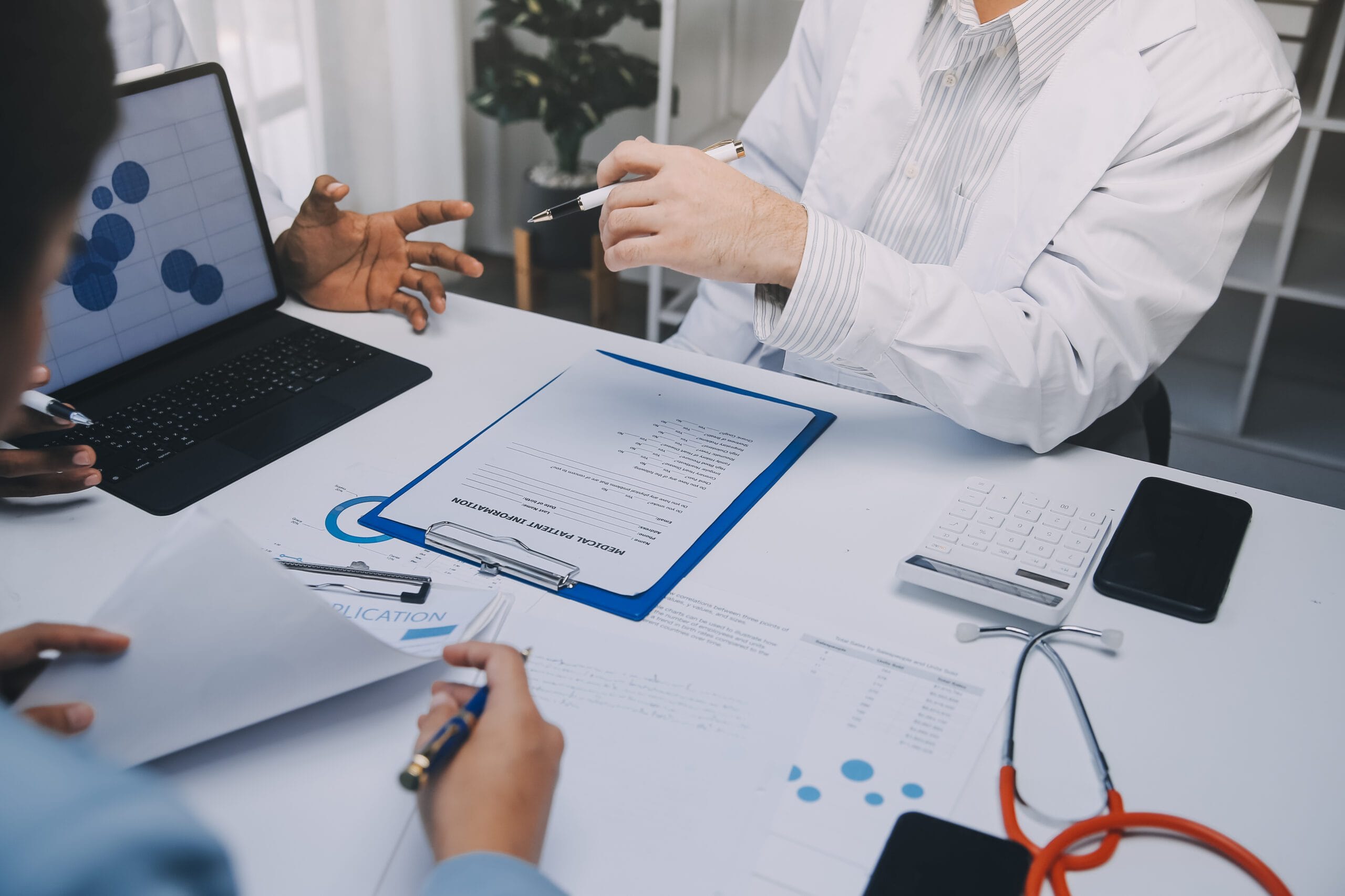 A healthcare provider reviewing prior authorization documents on a computer screen.