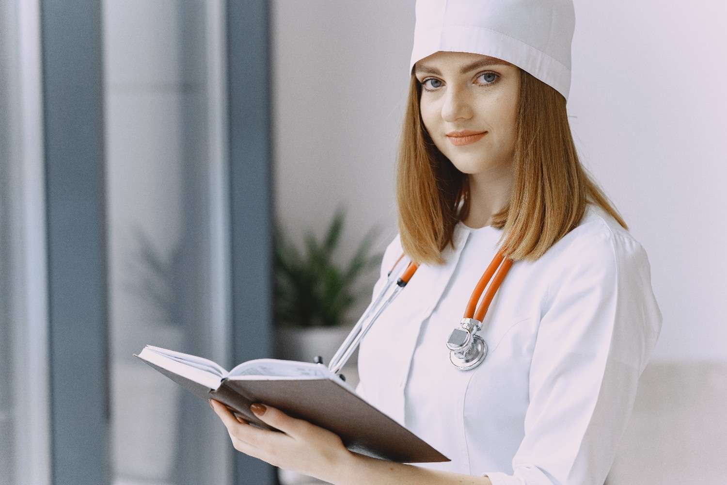 Female doctor holding a notebook, symbolizing efficient healthcare workflows supported by Virtual Telemedicine Services.