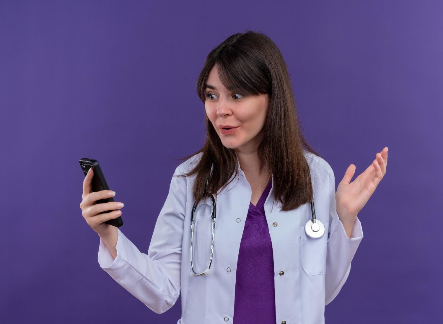 Female healthcare provider surprised while using a voice-activated device, showcasing the impact of voice search in healthcare.