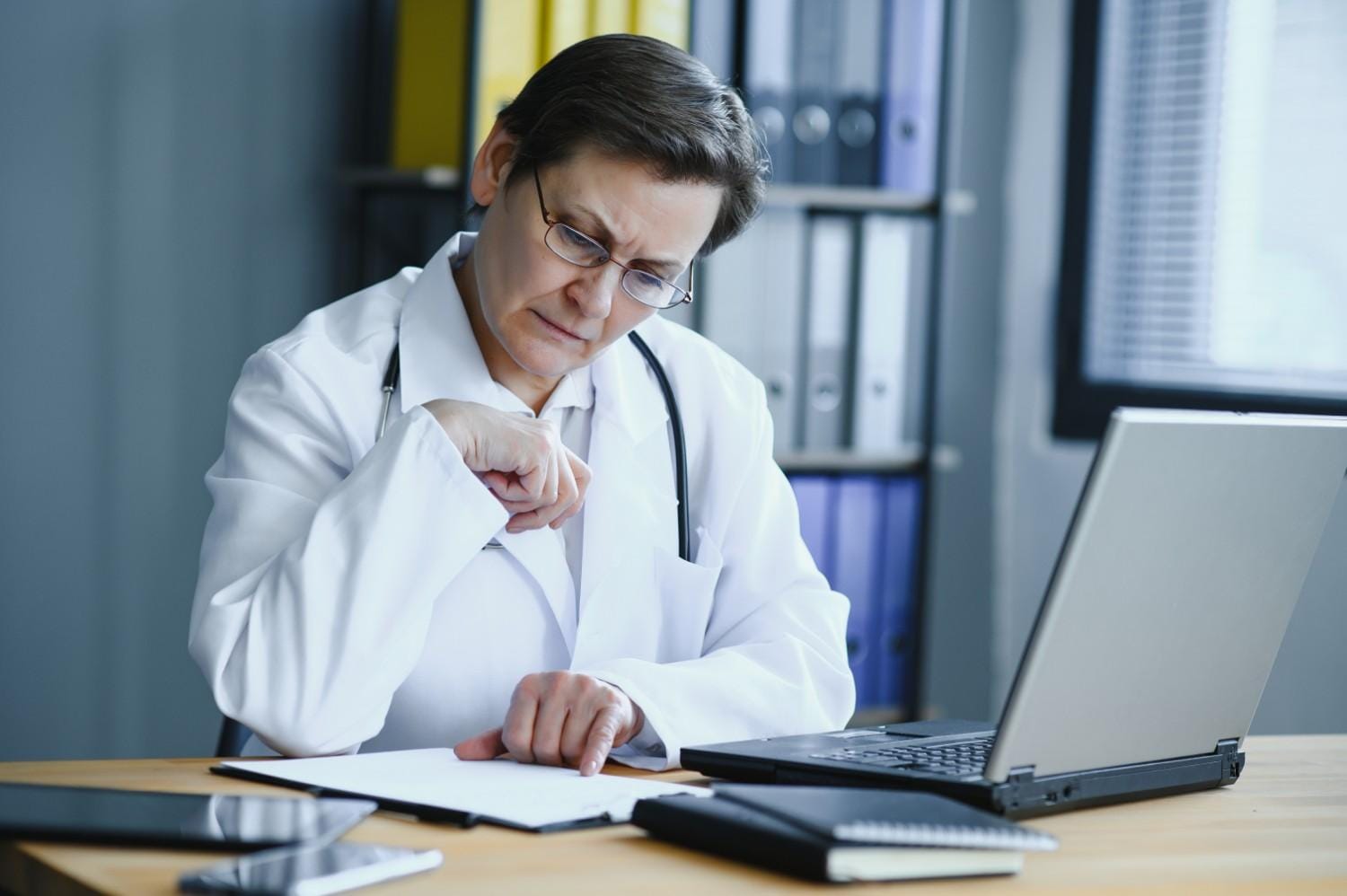 A medical coder analyzing patient records to reduce claim denials in Tennessee.