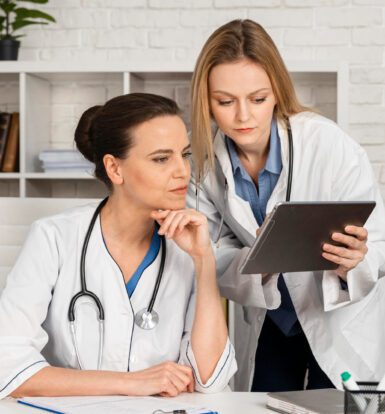 A medical scribe assisting a doctor with EHR documentation in a Rhode Island healthcare facility.