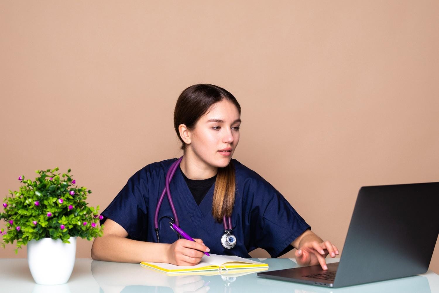 Healthcare Virtual Assistant in South Carolina managing patient data on a laptop with efficient support for medical practices.