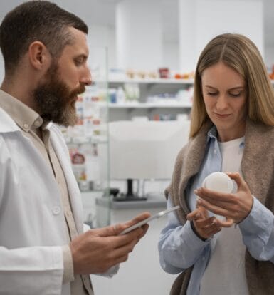 A billing expert reviewing LTC pharmacy claims on a computer.