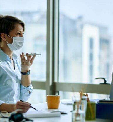 Medical Virtual Assistant in NYC wearing a mask, managing healthcare tasks remotely, focusing on administrative efficiency.